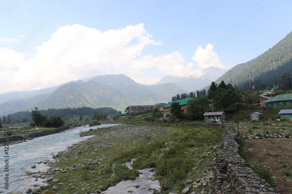 Beautiful scenic Lidder river flowing through Pahalgam Valley in Jammu & Kashmir. People enjoying here around the world.