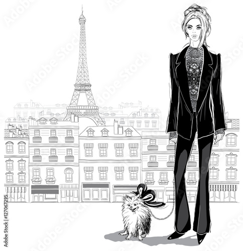 Fashion woman model in a pantsuit with a little dog on Paris cit