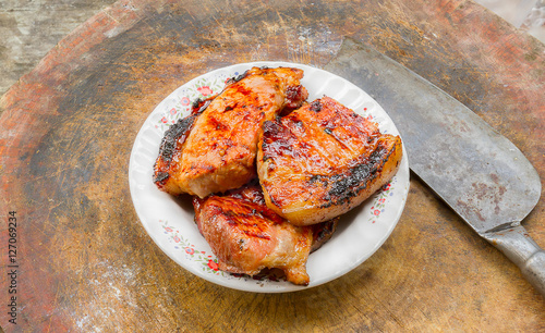 Crispy pork belly grilled on a wooden cutting board photo