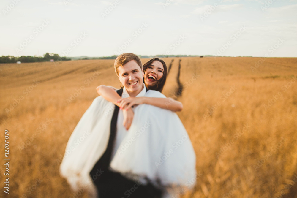 happy and young bride and groom having fun together happy and young bride and groom having fun together