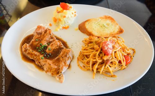 Dish of bread spaghetti with pork steak