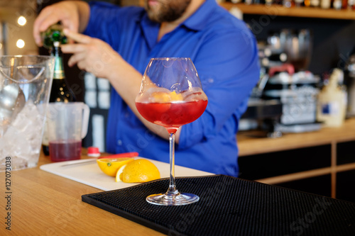 Barman preparing alcoholic cocktail for customer