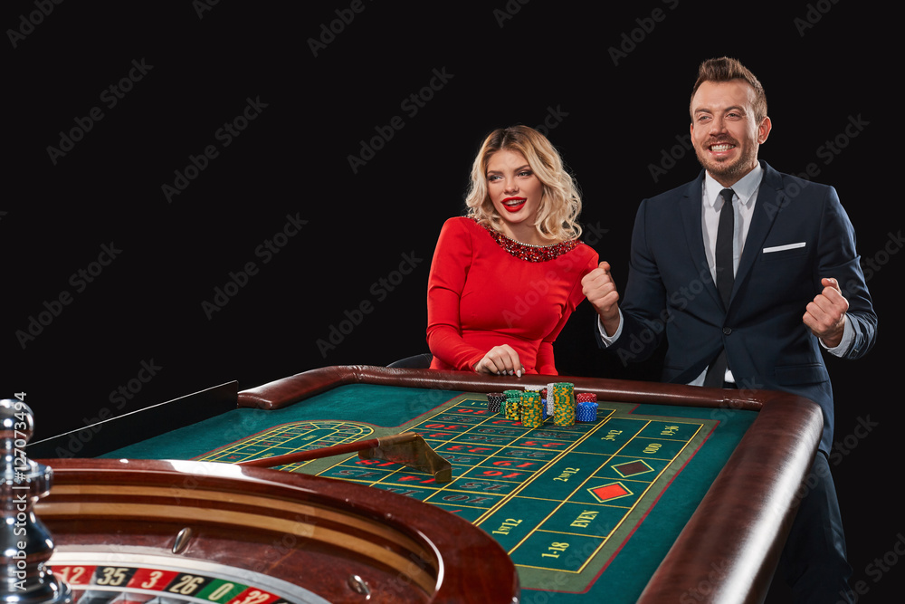 Couple playing roulette wins at the casino. Couple playing roulette wins at the casino.