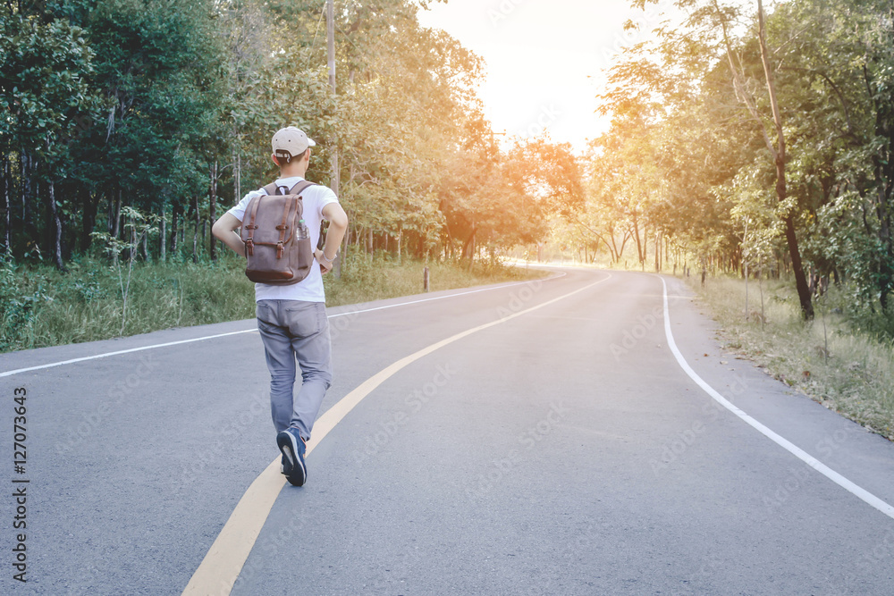 Asian man with backpack on nature background ,alone and wait to travel Asian man with backpack on nature background ,alone and wait to travel