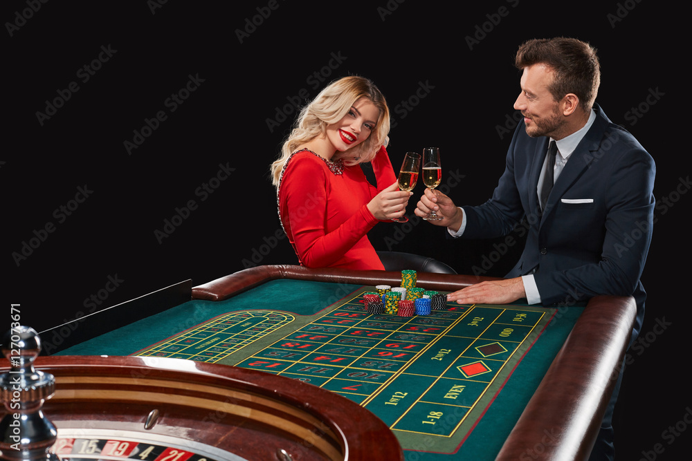 Couple playing roulette wins at the casino. Couple playing roulette wins at the casino.