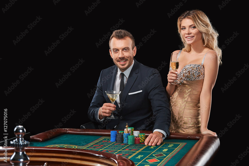 Couple playing roulette wins at the casino. Couple playing roulette wins at the casino.