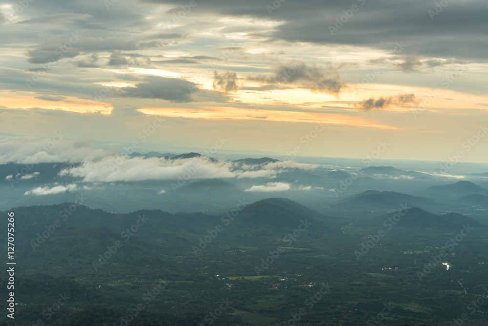 Mountain valley under mist and sunshine in the morning.