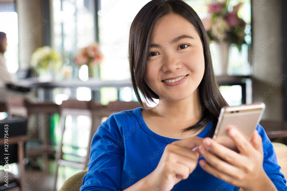 Woman use smartphone in cafe be happy
