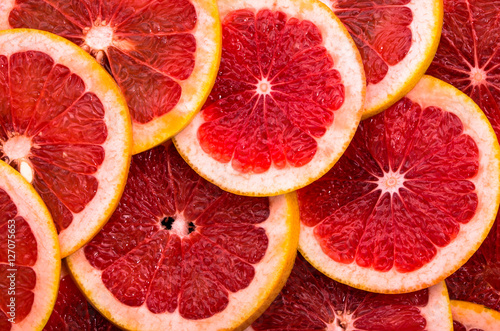 Texture of grapefruit slices  close view  overhead  citrus backgrounds