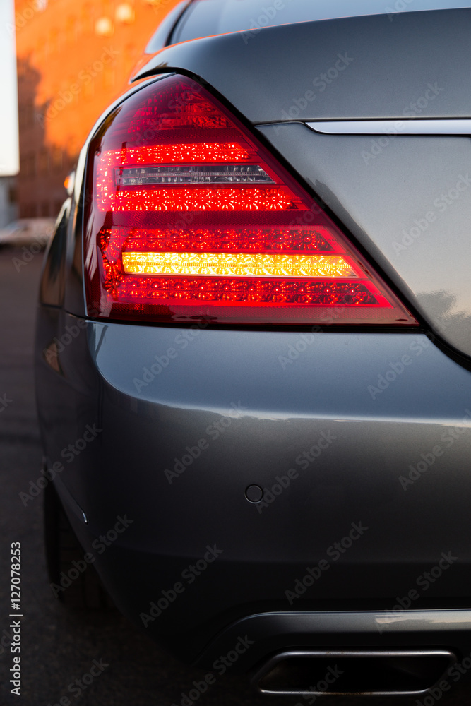 Exterior of the famous luxury car from German vendor. Rear lamp with oragne light on.