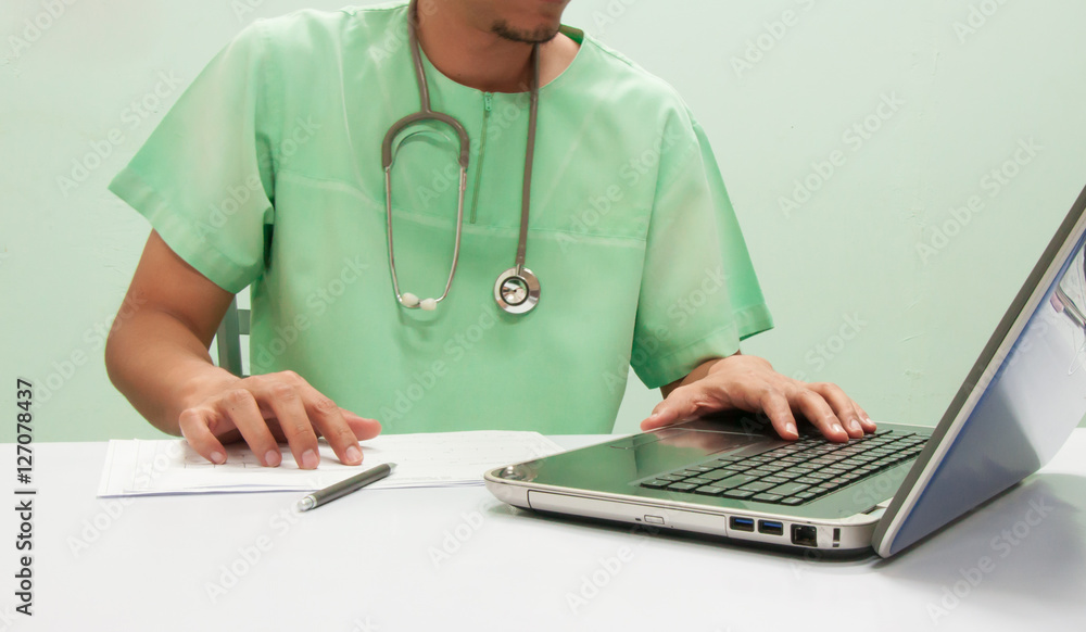 Doctor working with computer notebook at desk Doctor working with computer notebook at desk