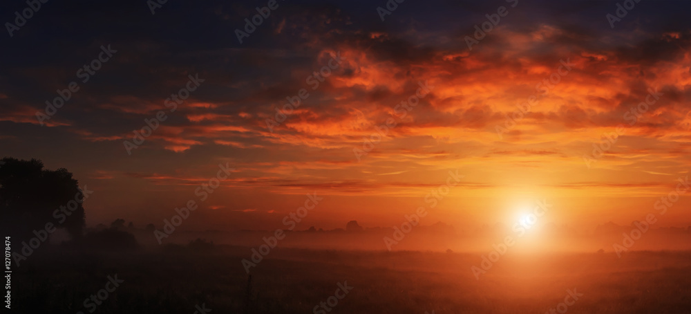 majestic dramatic scene. fantastic foggy sunset over the meadow with colorful clouds on the sky. picturesque rural landscape, misty morning. color in nature. beauty in the world majestic dramatic scene. fantastic foggy sunset over the meadow with colorful clouds on the sky. picturesque rural landscape, misty morning. color in nature. beauty in the world