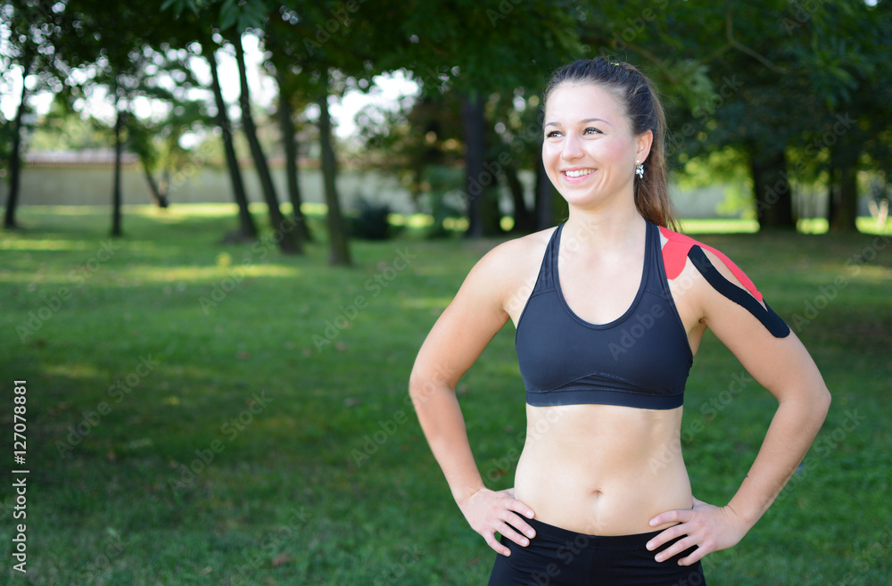 Young beauty woman with kinesiology tape on her shoulder. Young beauty woman with kinesiology tape on her shoulder.