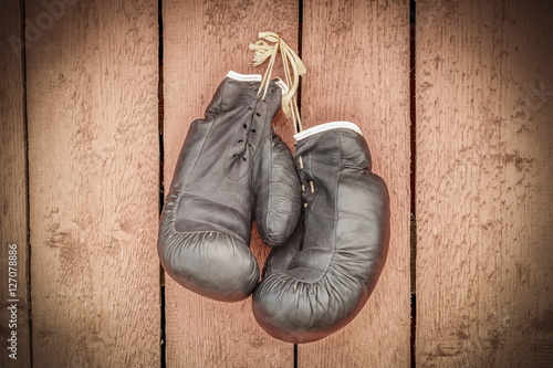Old boxing gloves on wooden wall © Stock Photos & Video