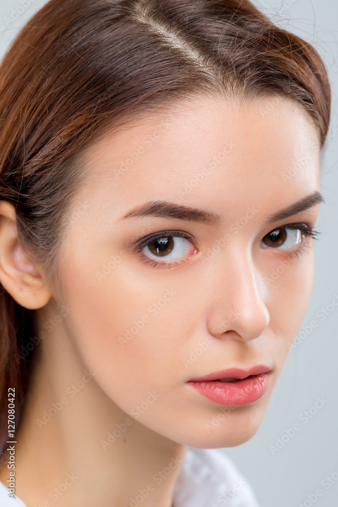 Fototapeta premium The face of woman on gray background