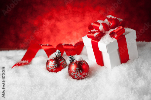 christmas gift with balls bow red background