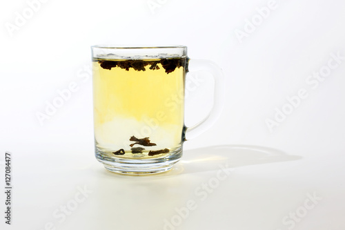 transparent cup of tea with custard on white background