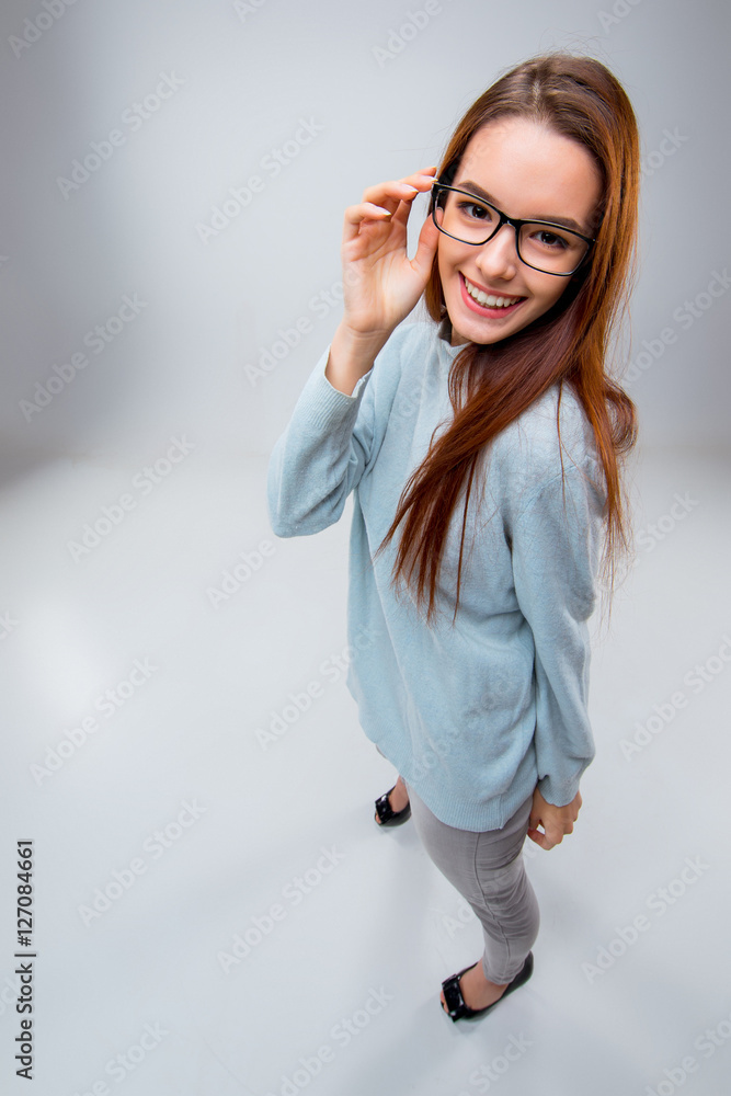 The smiling young business woman on gray background The smiling young business woman on gray background