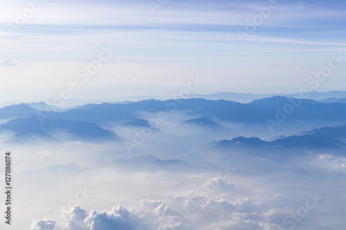 Blue sky and mountains view from airplane stylized hipster background with copyspace