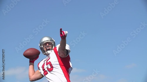 Quarterback looks and shouts to throw ball.