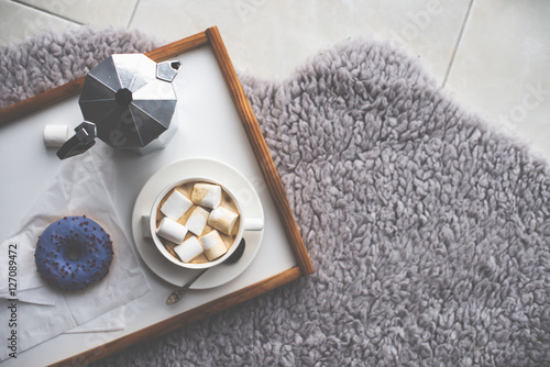 Warm cozy home. Tray and cup of coffee with marshmallows 