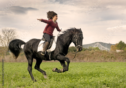 riding girl and black stallion