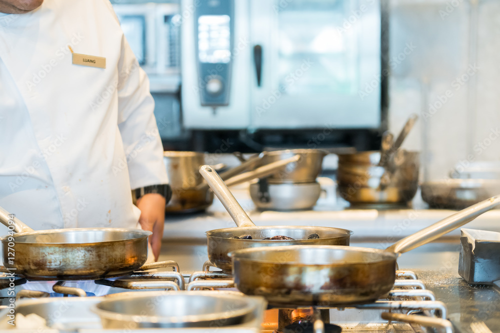 chef preparing food in a restaurant kitchen
chef preparing food in a restaurant kitchen