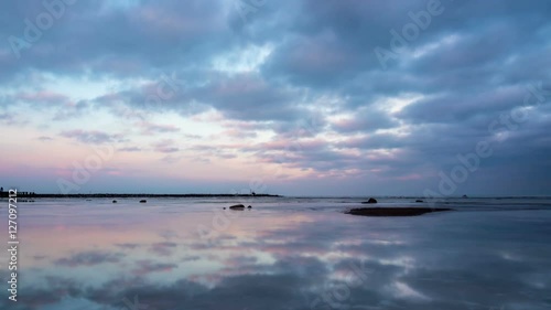 Sunset sky, clouds, ice reflection slightly zoom-in timelapse