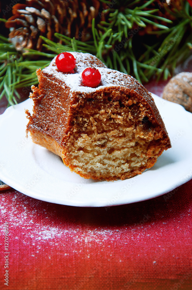 Piece of christmas pudding cake decorated with berries sprinkled Piece of christmas pudding cake decorated with berries sprinkled