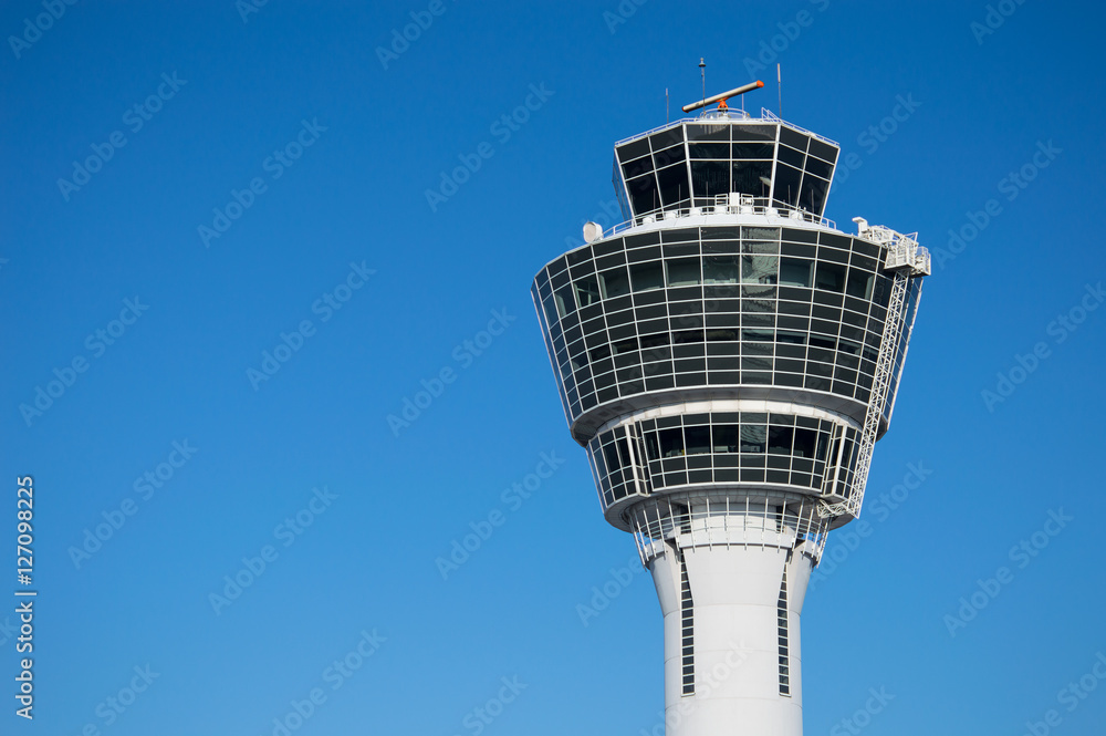 Modern air traffic control tower in international passenger airport over clear blue sky Modern air traffic control tower in international passenger airport over clear blue sky