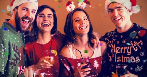 Composite image of portrait of festive friends in bar