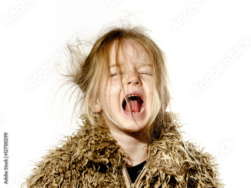 Disheveled preschooler girl with long hair crying photo