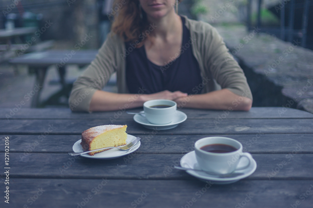 Woman having coffee and cake outside Woman having coffee and cake outside