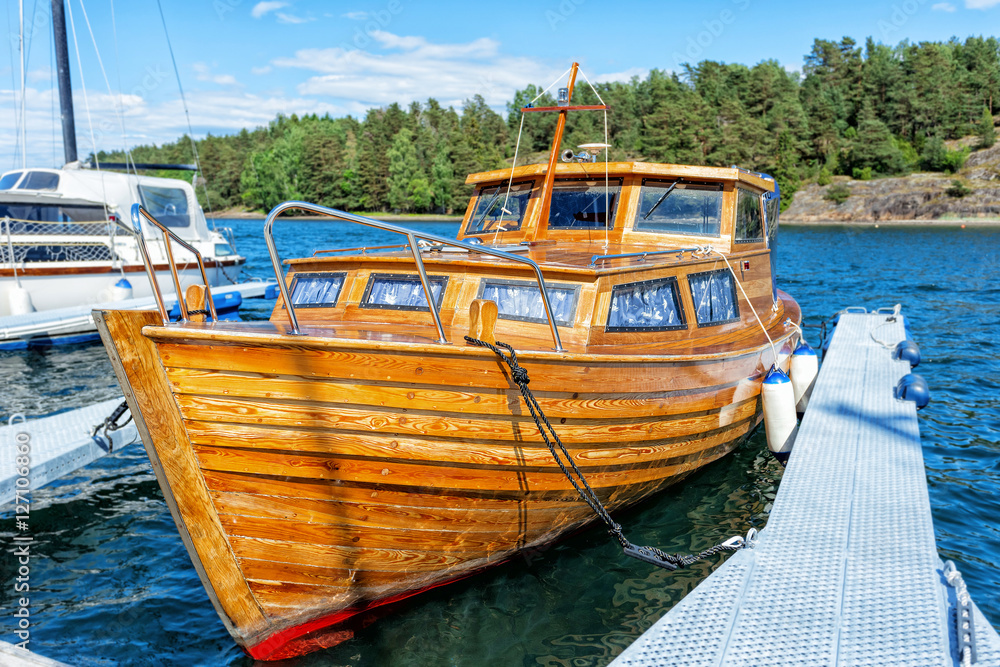 Norway. Wooden boat made fast to the pier.