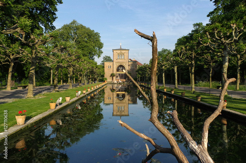 Stuttgart, Germany - MAI 13, 2015: Zoo Wilhelma. Artificial pond with aquatic plants. Ancient palace in the background.