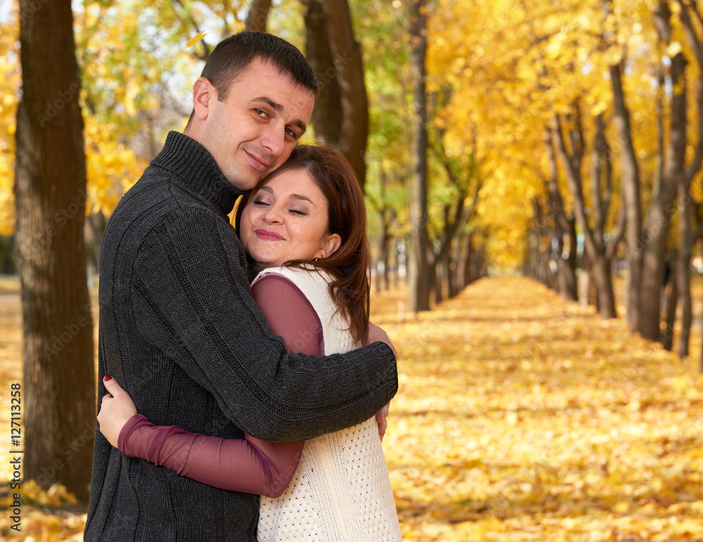 romantic people, happy adult couple embrace in autumn city park, trees with yellow leaves, bright sun and happy emotions, tenderness and feelings romantic people, happy adult couple embrace in autumn city park, trees with yellow leaves, bright sun and happy emotions, tenderness and feelings