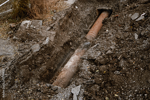Old Rusty Pipe for water in a trench open for repair top view