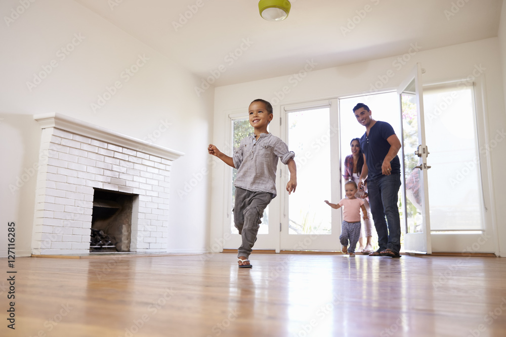 Excited Family Explore New Home On Moving Day Excited Family Explore New Home On Moving Day