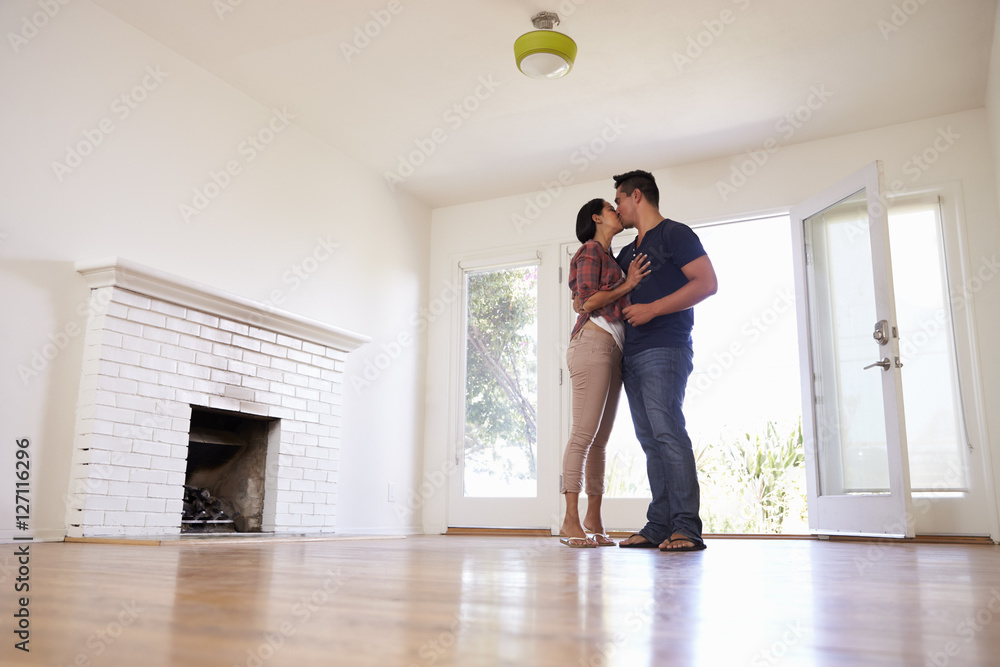 Romantic Couple In New Home On Moving Day Romantic Couple In New Home On Moving Day