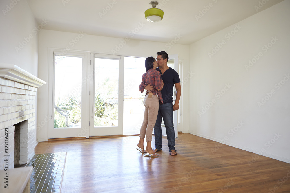 Romantic Couple In New Home On Moving Day Romantic Couple In New Home On Moving Day