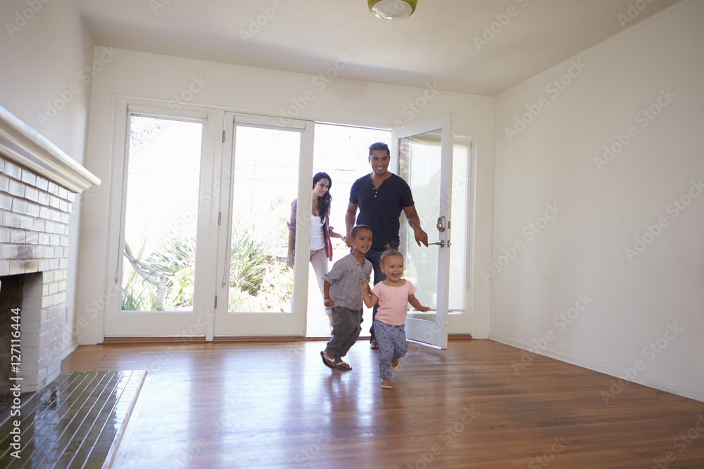 Excited Family Explore New Home On Moving Day Excited Family Explore New Home On Moving Day