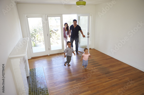 High Angle View Of  Family Exploring New Home On Moving Day © Monkey Business