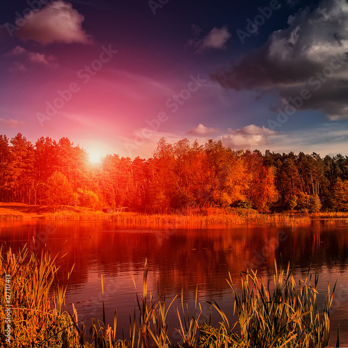 beautiful landscape. wonderful multi colored sunset sky with majestic clouds over the lake in the forest breathtaking scenery. fantastic picturesque scene. color in nature.