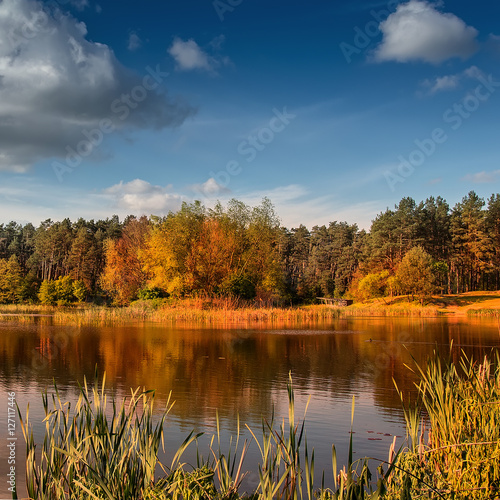 beautiful landscape. wonderful autumn sunny day. sky with majestic clouds over the lake in the forest breathtaking scenery. fantastic picturesque scene. color in nature.