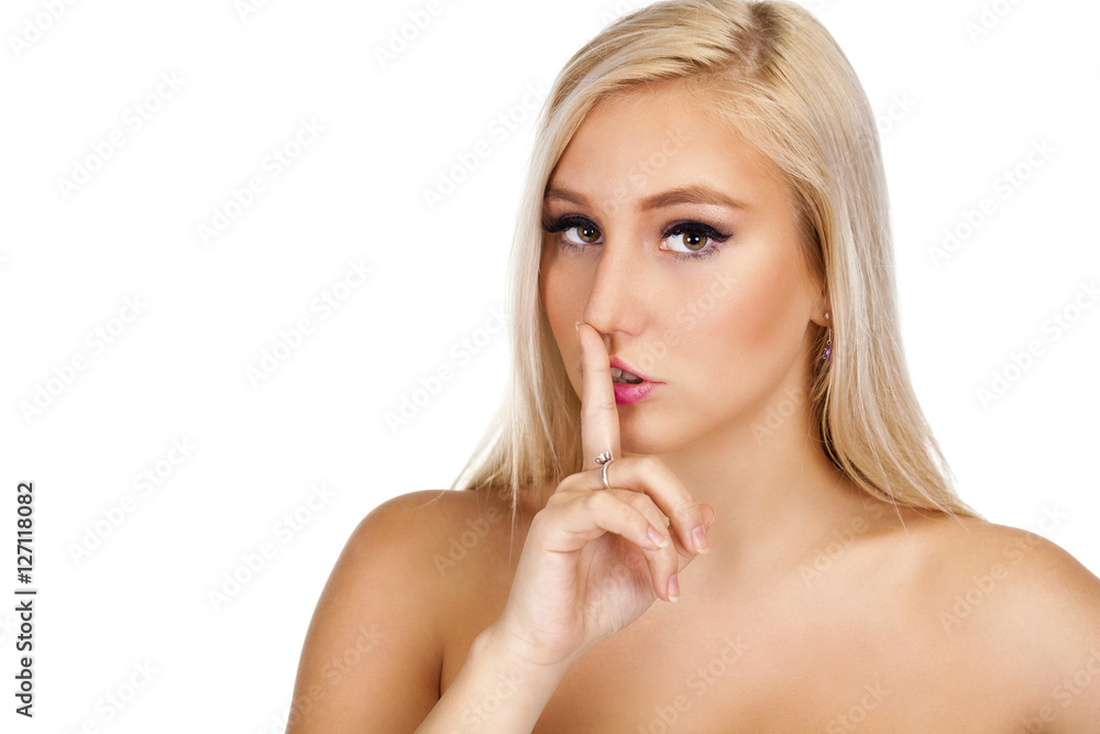 Young beautiful blonde woman has put forefinger to lips as sign Young beautiful blonde woman has put forefinger to lips as sign