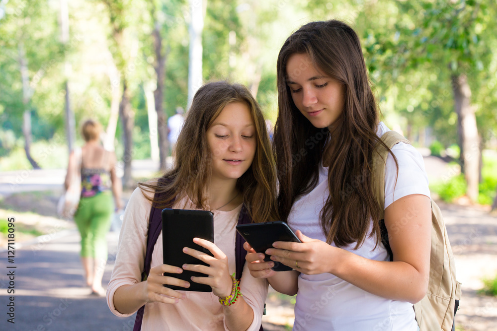 two smiling girls with the tablets two smiling girls with the tablets