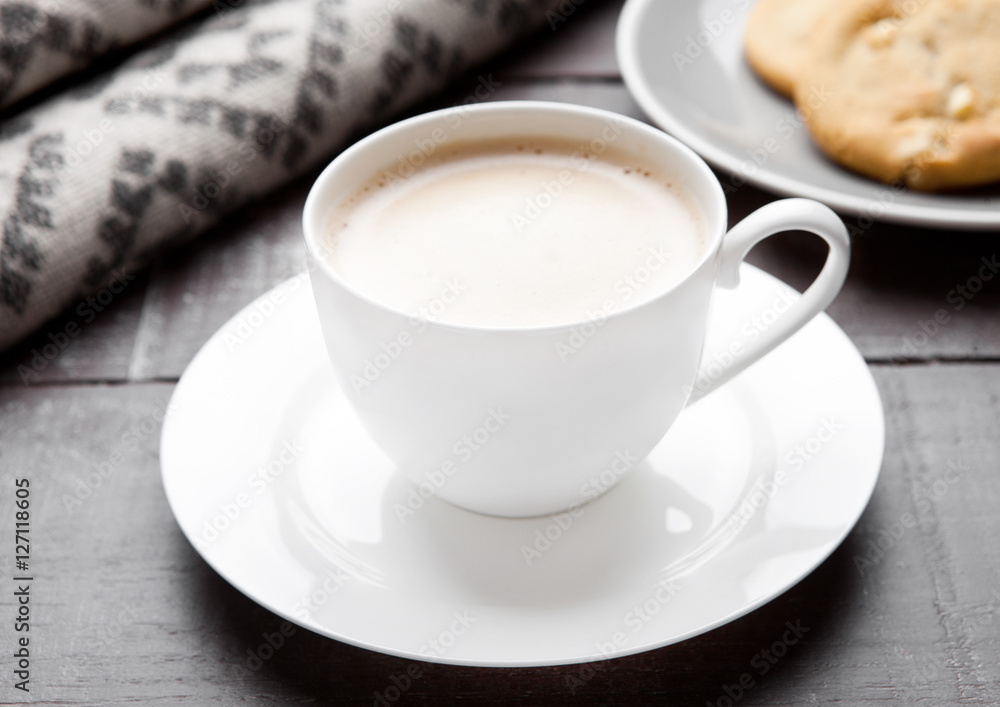 Cup of cappuccino with grey wool scarf and cookies Cup of cappuccino with grey wool scarf and cookies