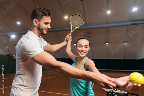 Positive woman learning how to play tennis