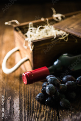 Red wine bottle and wooden crate