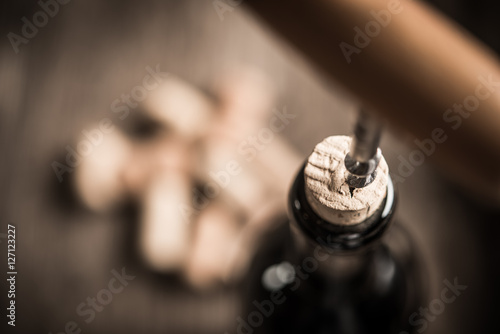 Opening wine bottle with corkscrew in restaurant